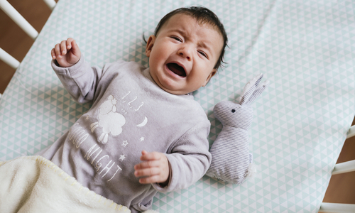 Baby crying in bed.jpg
