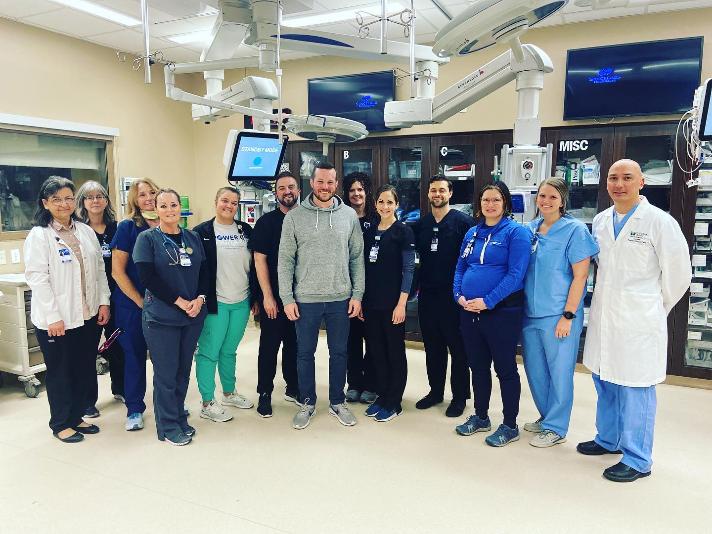 Ryan standing with medical care team