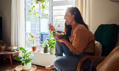 Woman eating on couch.jpg