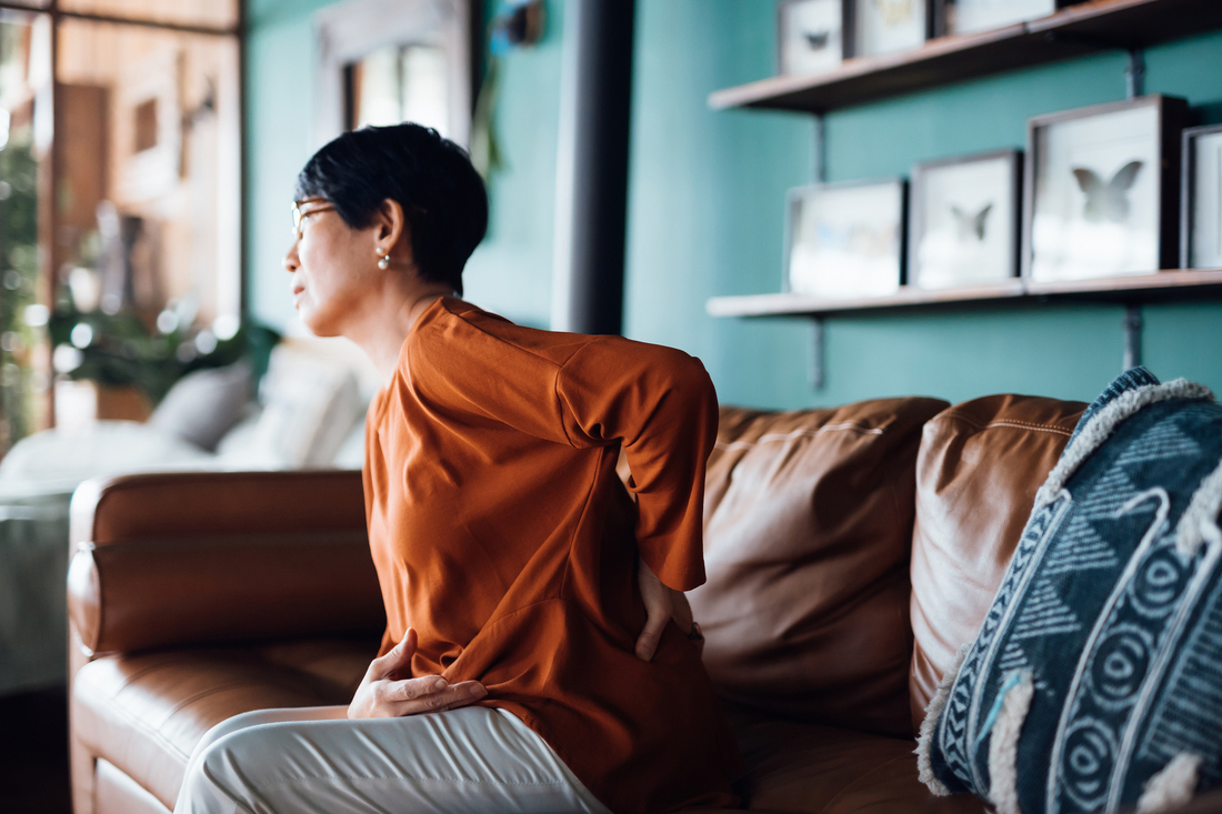 Woman holding lower back in pain.jpg