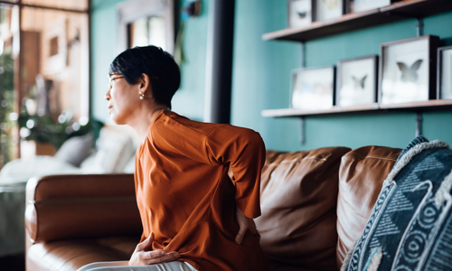 Woman holding lower back in pain.jpg