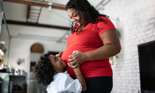 Happy pregnant woman with young child.jpg
