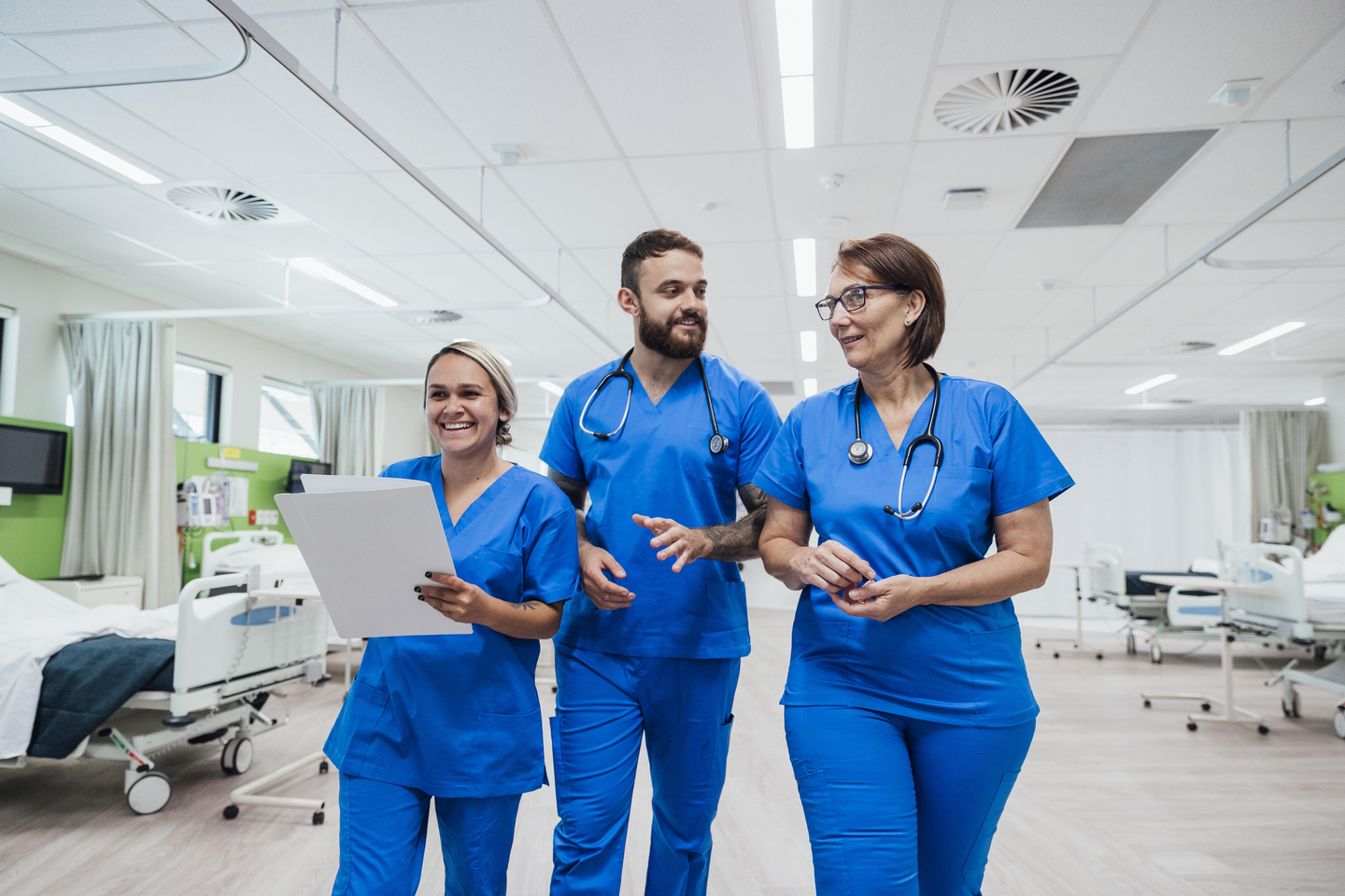 Three nurses walking and talking