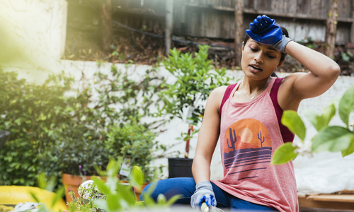 Woman wiping sweat from forehead.jpg