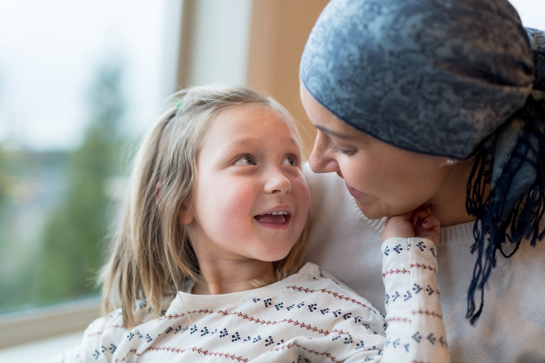 Mom with cancer holding her daughter.jpg