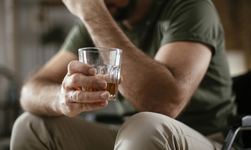 Man holding glass of alcohol