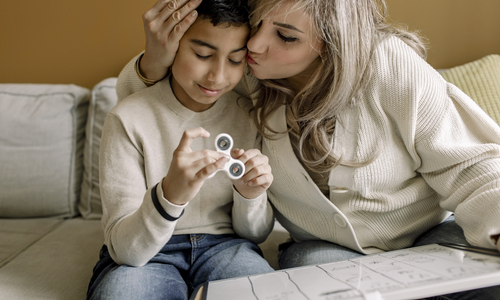Boy playing with fidget toy.jpg