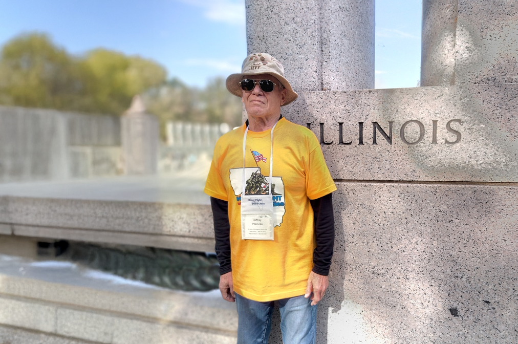 Man standing in front of monument outside