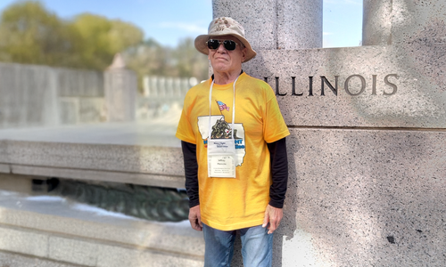 Man standing in front of monument outside