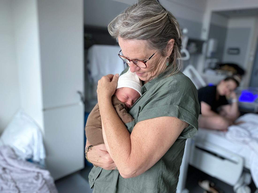 Grandma at hospital holding infant