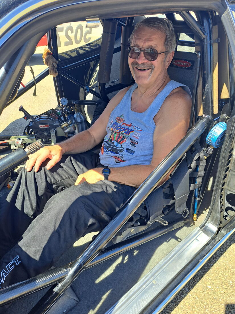 Tom Roschen smiling in racecar driver's seat