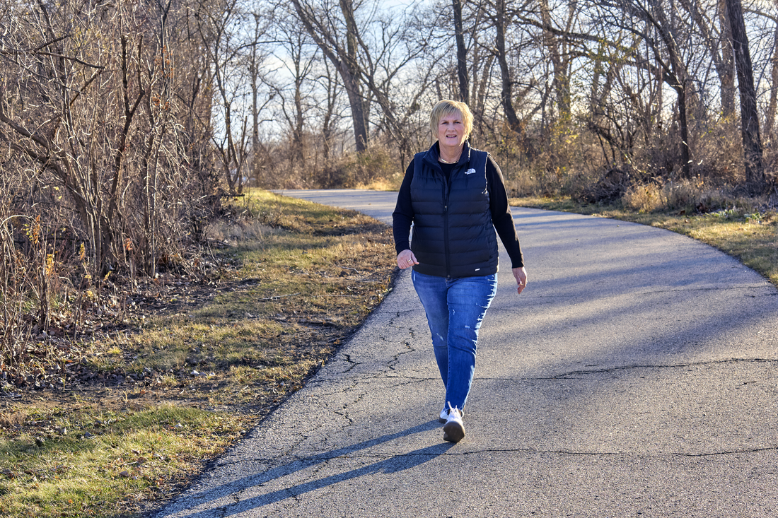 Karen Ratz walks along Cedar Rapids trail