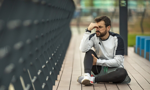 Man holding shoulder in pain.jpg