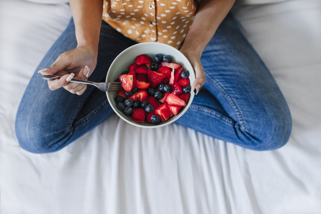 Woman holding bowl of food fruit.jpg