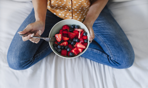 Woman holding bowl of food fruit.jpg