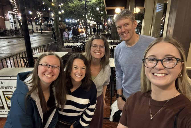 Coordinators, APDs and the Program Director smiling at the camera outside at a restaurant..jpg
