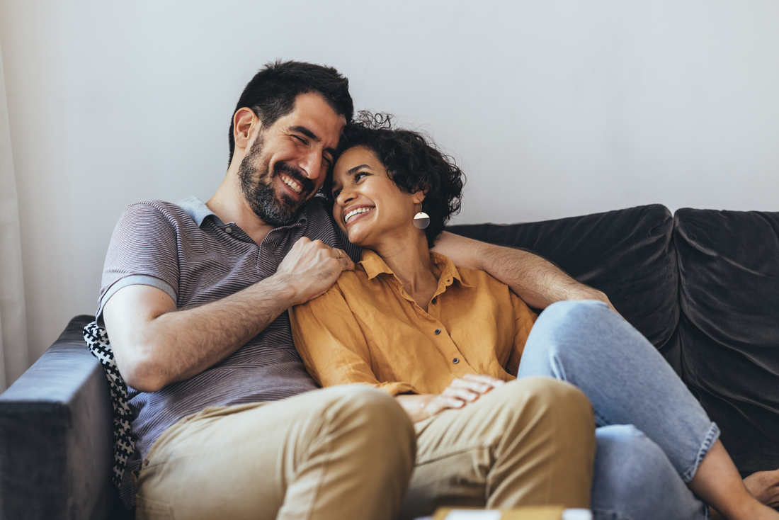 Happy couple sitting on couch.jpg