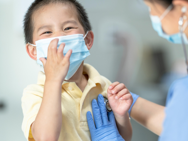 Nurse listening to child's heart with child laughing.jpg