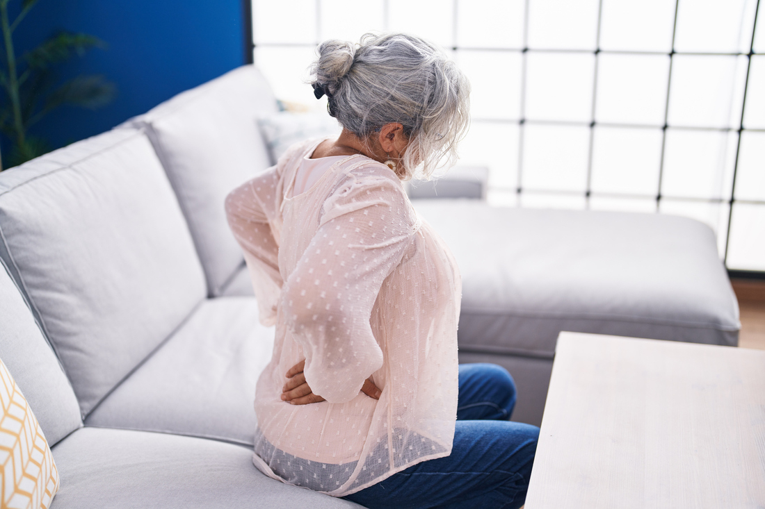 Woman holding back in pain.jpg