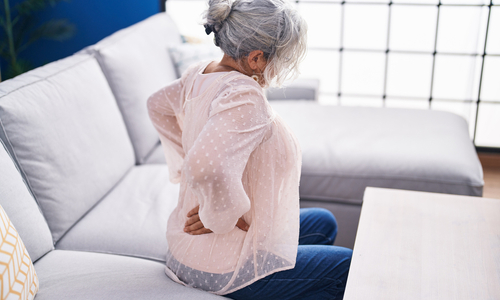 Woman holding back in pain.jpg