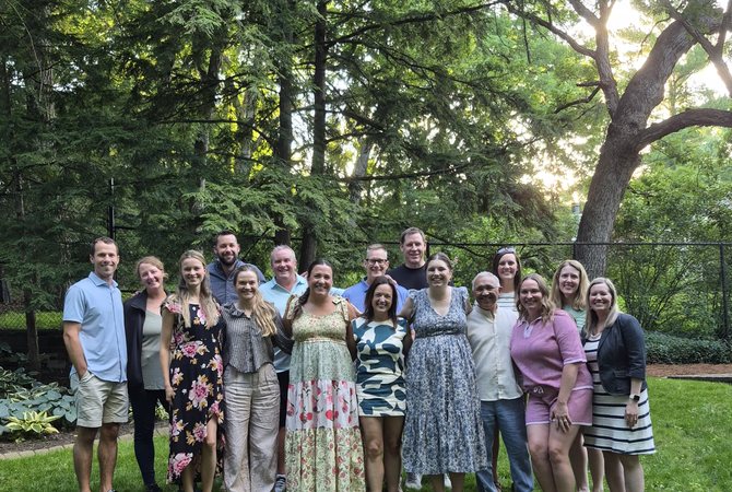 A group of residents and faculty standing outside, smiling at the camera..jpg
