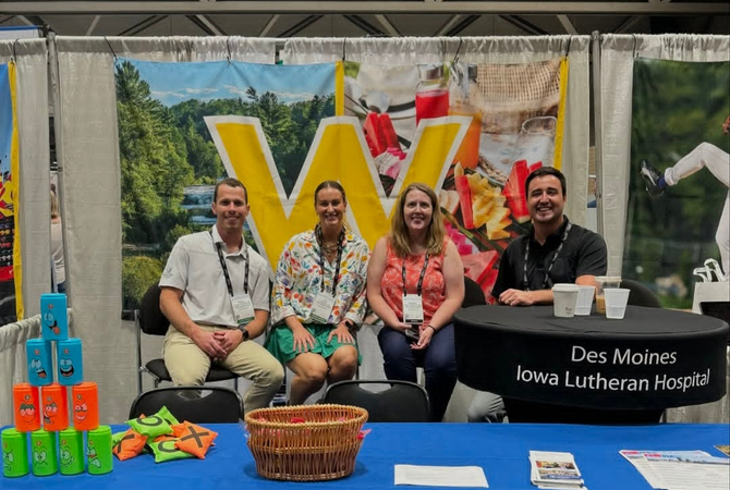 Family Medicine Residents at a table smiling at camera.jpg
