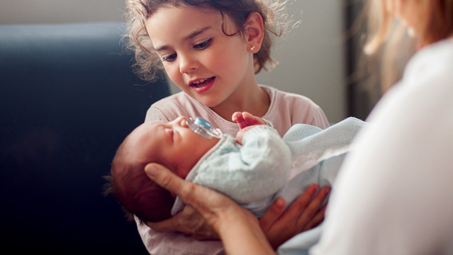 Finley Health Capital Campaign Child holding newborn.jpg