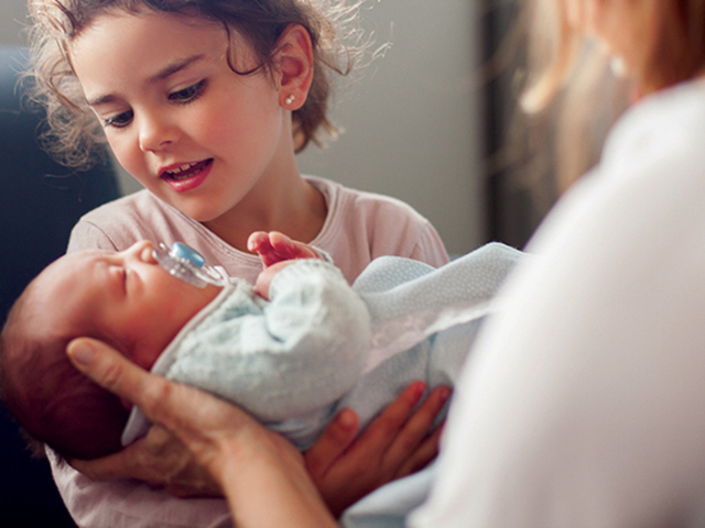 Finley Health Capital Campaign Child holding newborn.jpg