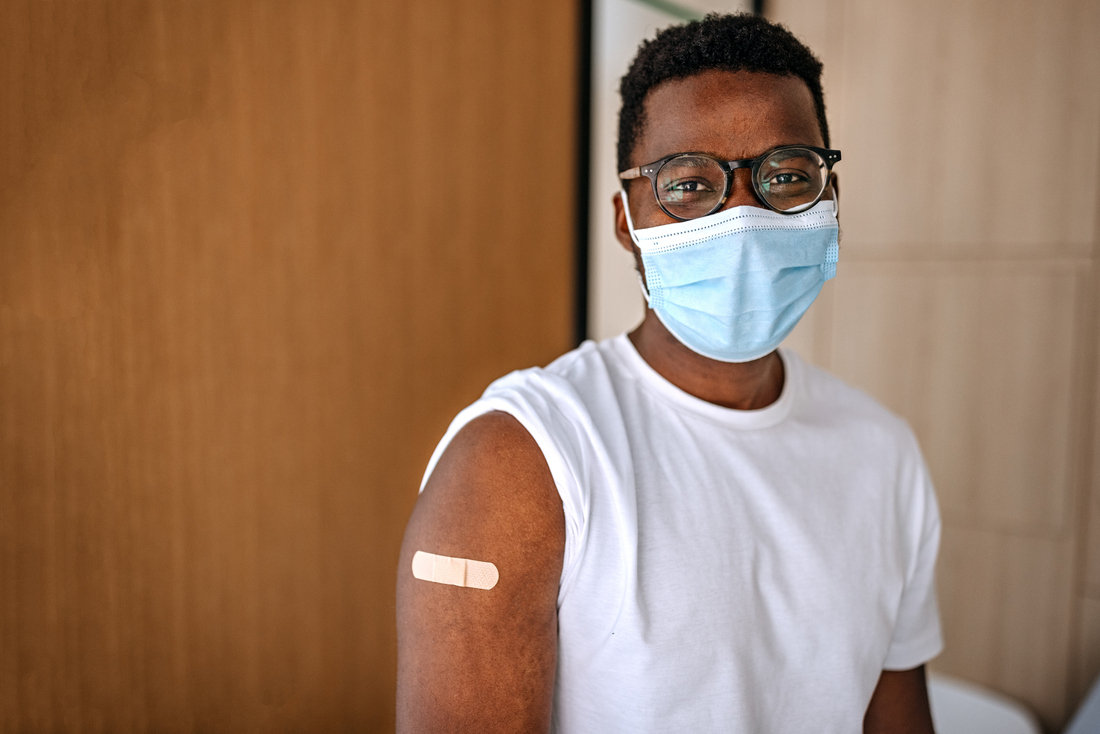 Man with vaccine bandage.jpg