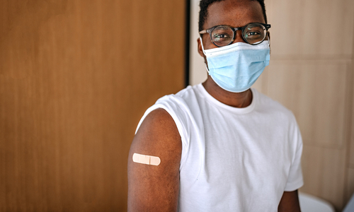 Man with vaccine bandage.jpg