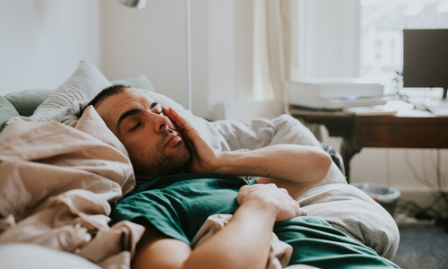 Tired man lying on couch.jpg