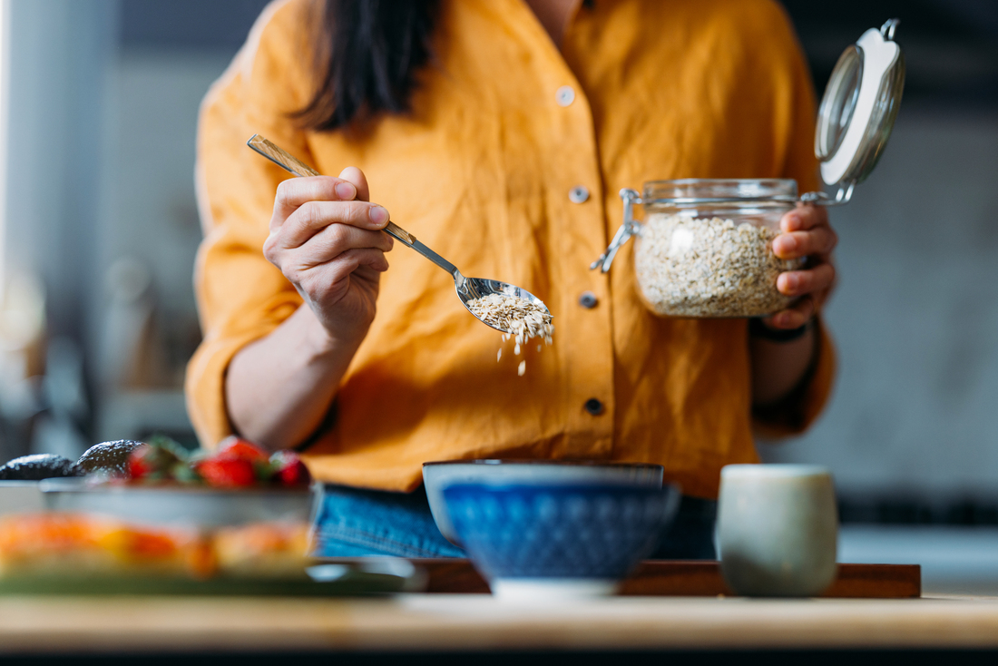 Woman putting oats in a bowl.jpg