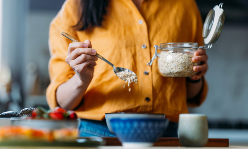 Woman putting oats in a bowl.jpg