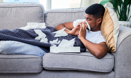 Sick man blowing nose.jpg