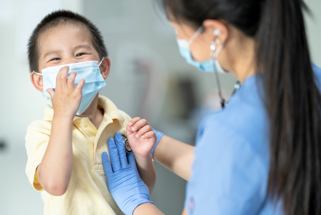 Nurse listening to child's heart with child laughing.jpg