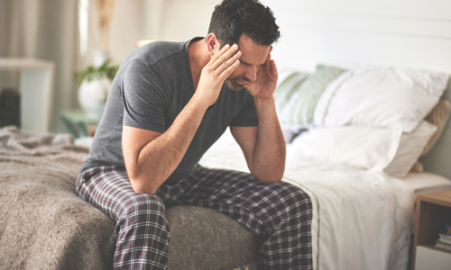 Erectyle dysfunction - frustrated man sitting in bed.jpg