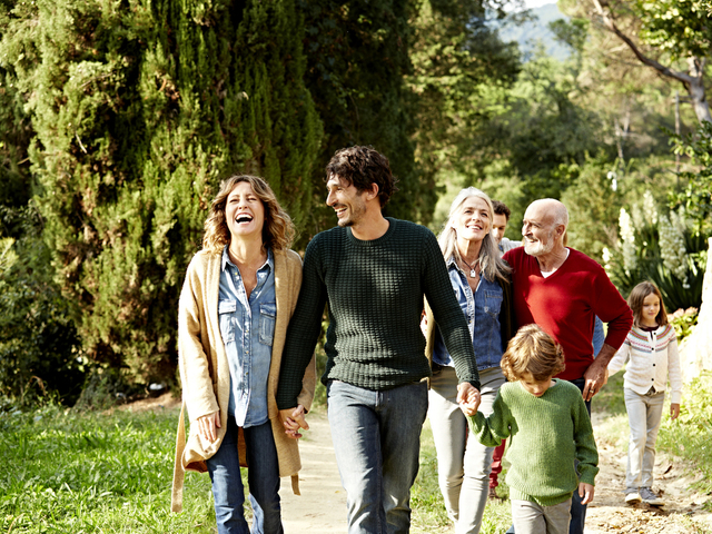 Happy multi-generation family taking a walk outdoors.jpg
