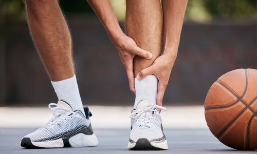Man holding ankle in pain.jpg