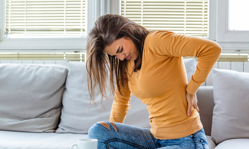 Woman holding back in pain.jpg