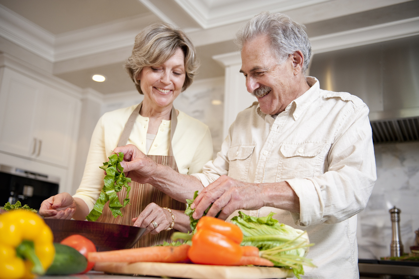Senior couple preparing food in kitchen.jpg