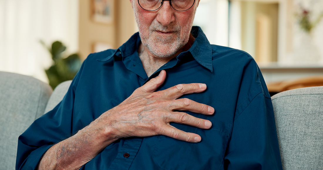 Senior man clutching chest with A-fib