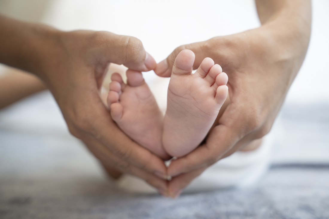Baby feet with hand heart.jpg