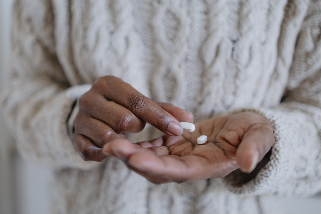 Woman holding a pill.jpg