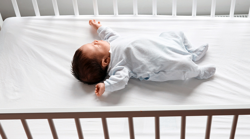 Newborn sleeping in crib.jpg