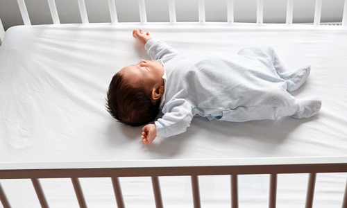 Newborn sleeping in crib.jpg