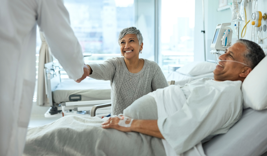 Happy male patient in hospital with happy woman.jpg