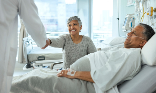 Happy male patient in hospital with happy woman.jpg