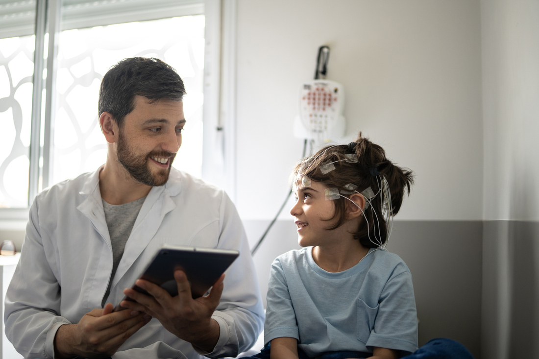 Child talking to doctor while taking EEG