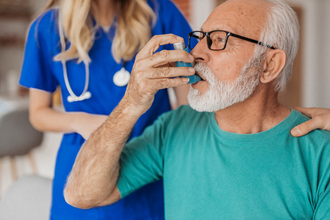 Man taking puff of inhaler