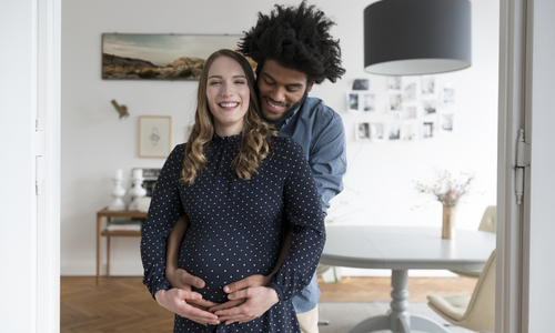 Pregnant woman with man hugging her.jpg